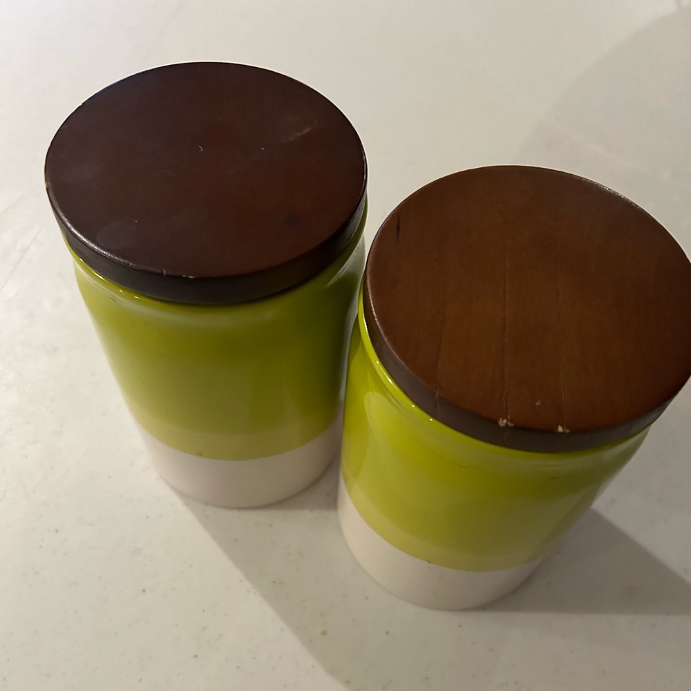 Set of two lime green stoneware canisters with wood lids